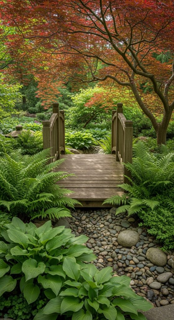 Decorative wooden garden bridge arching over stream surrounded by lush plantings