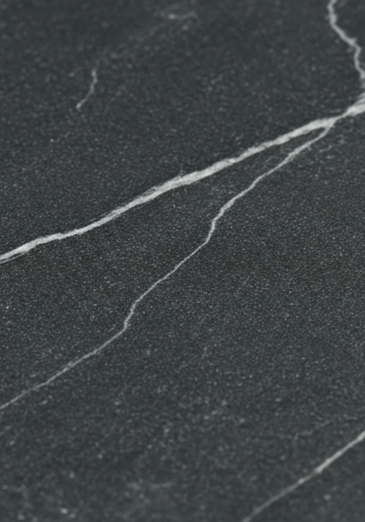 Close-up of charcoal gray soapstone kitchen countertop showing natural veining