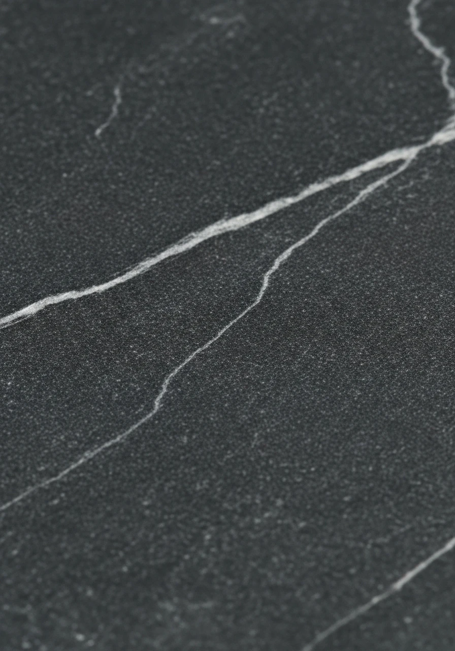 Close-up of charcoal gray soapstone kitchen countertop showing natural veining