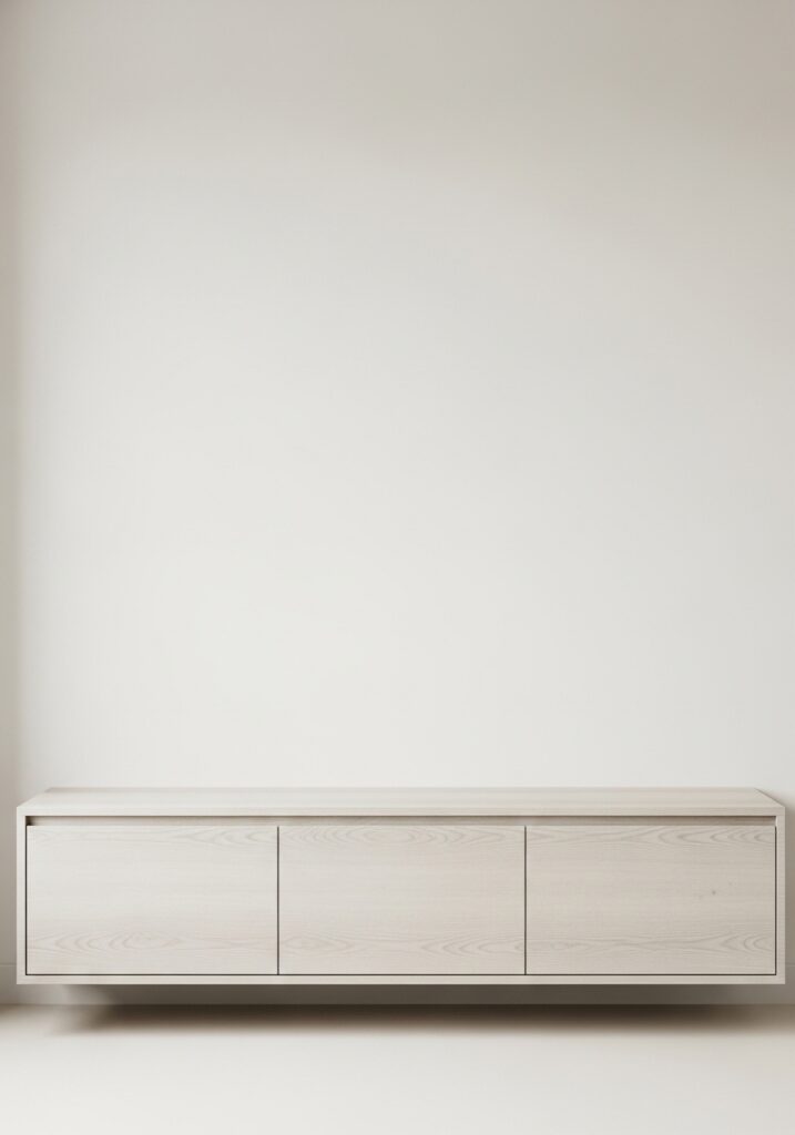 Closed storage cabinets hiding clutter in minimalist living room

