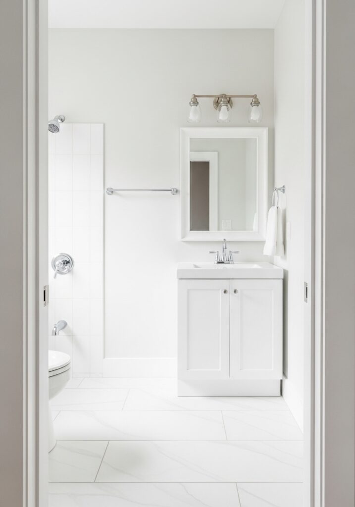 All-white small bathroom appearing larger with light colors