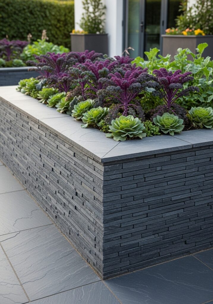Raised garden bed with dry-stacked slate walls and ornamental vegetables