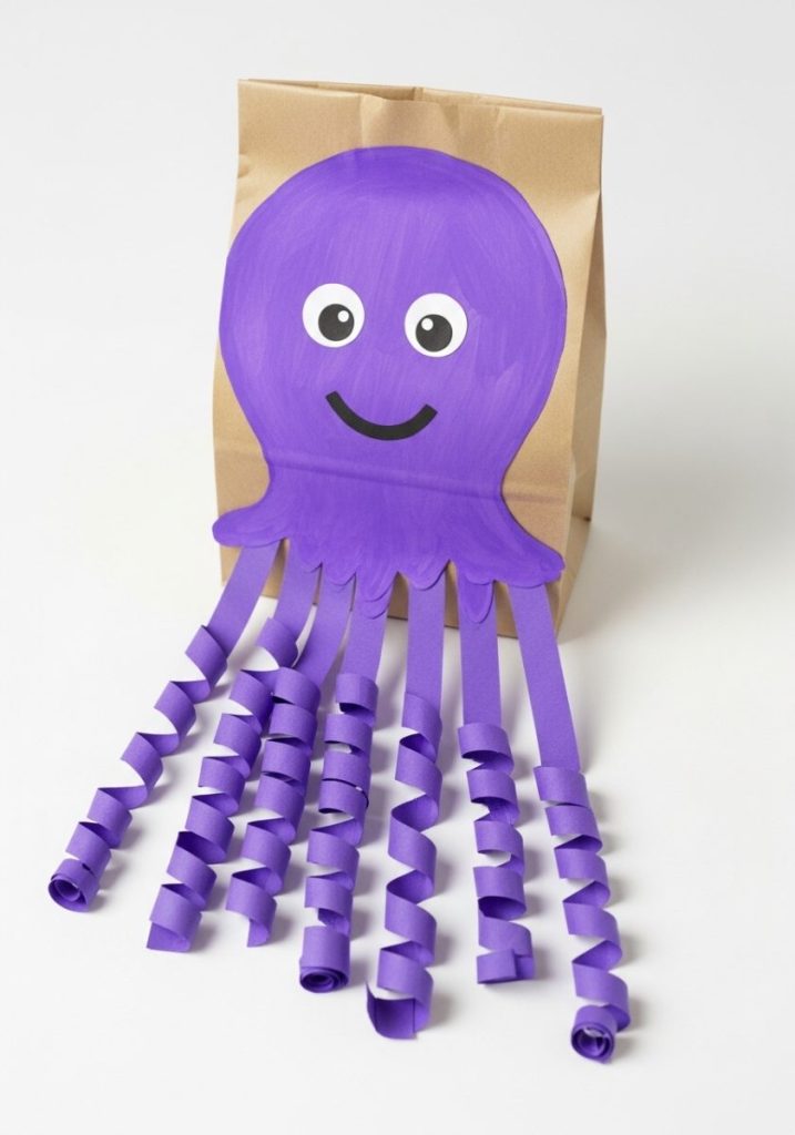 Paper bag octopus craft kids brown paper lunch bag stuffed sealed painted bright purple happy face front eight curled purple paper strip tentacles fun playful charming summer ocean craft