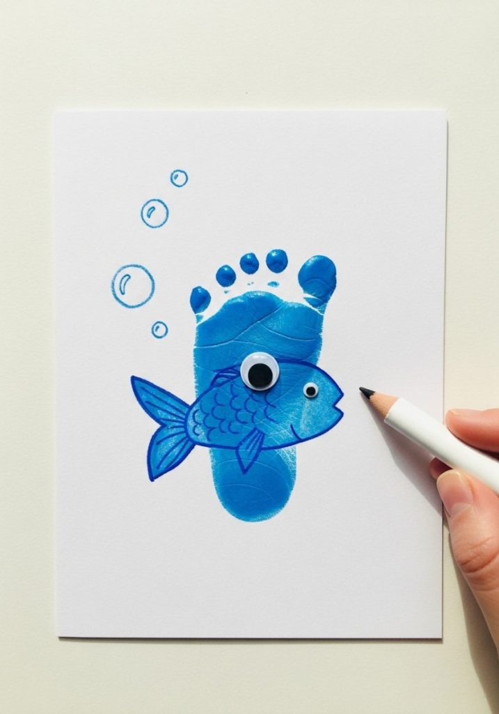 Baby footprint fish craft tiny baby footprint painted bright blue white card heel fish body toes fish tail googly eye heel bubbles drawn white crayon precious sweet charming