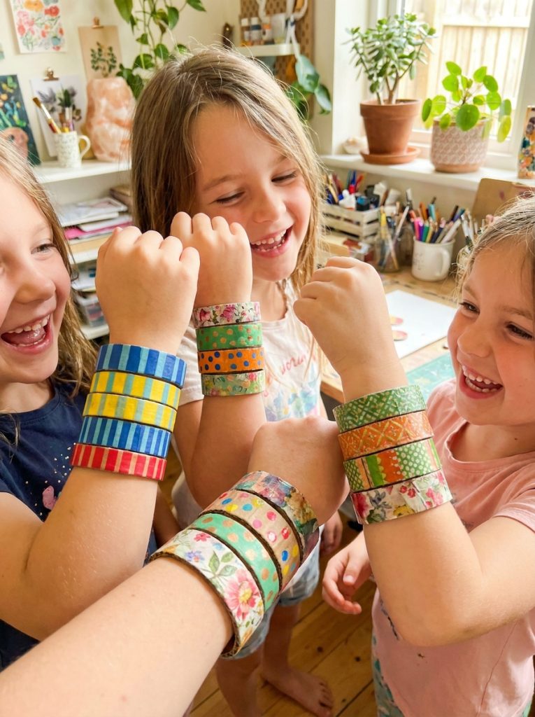  Handmade cardboard paper bangles in colorful washi tape and painted patterns worn on wrists