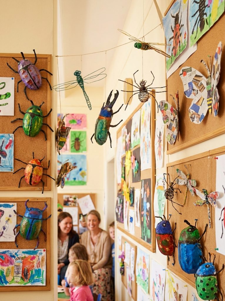 School insect art project display showing multiple kids bug creations in paint collage and mixed media as impressive gallery 