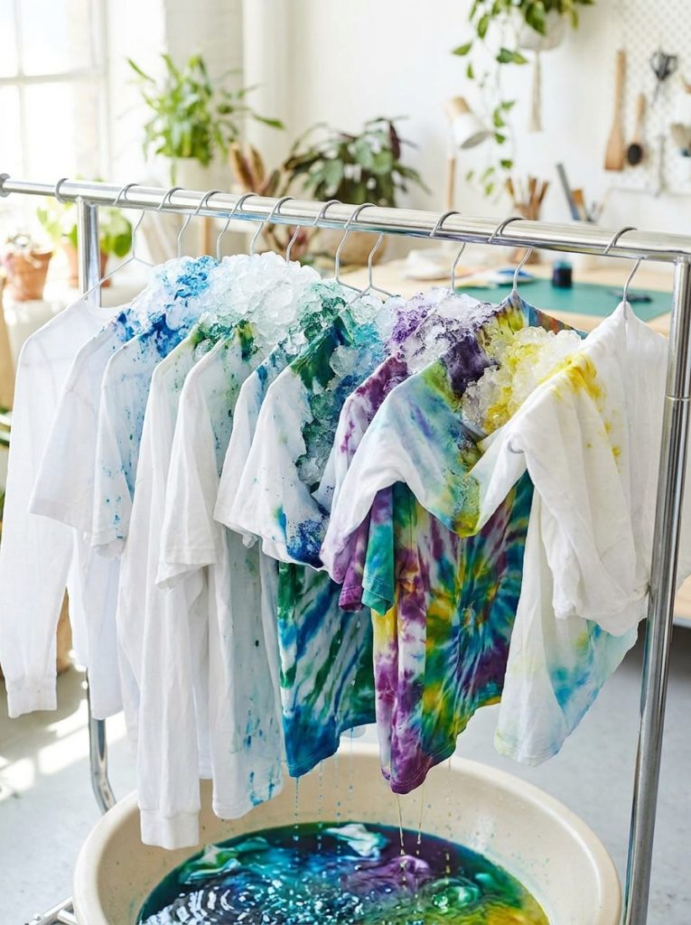 Beautiful ice tie dye pattern with fabric on rack covered in ice with powdered dye creating unique unpredictable patterns as ice melts